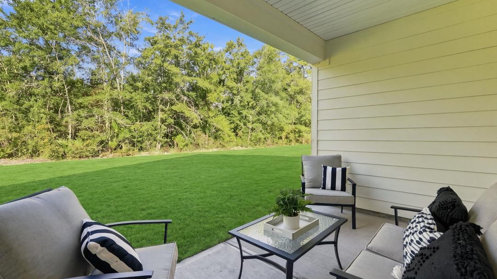Covered rear patio providing shaded outdoor living and entertaining space overlooking the backyard.