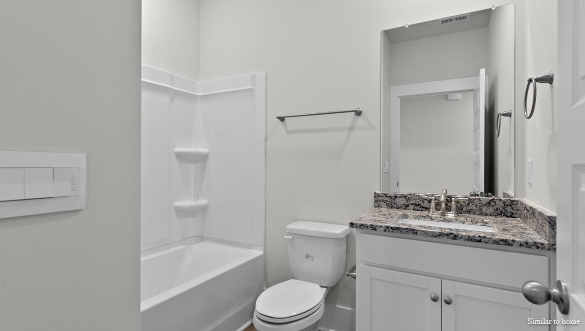 Primary bathroom in the Martin by D.R. Horton featuring modern finishes, ample counter space, and a functional layout.