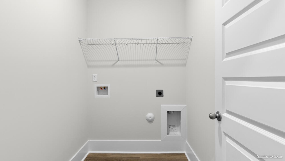 Convenient laundry room in the Martin by D.R. Horton providing functionality and organization.
