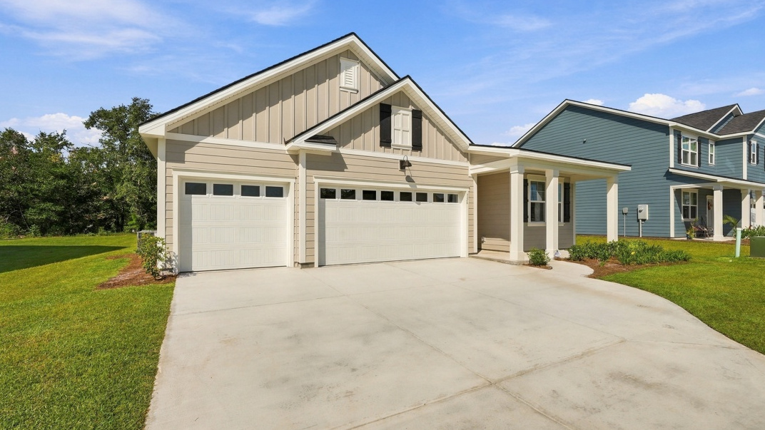 Side view of Front exterior of the Martin floor plan by D.R. Horton showcasing a spacious three-car garage, attractive architectural details, and welcoming entryway.