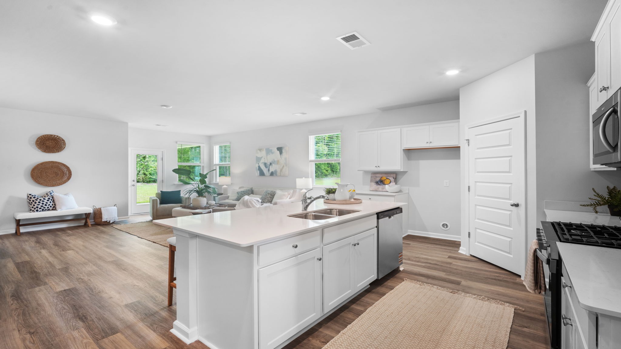 Open-concept kitchen in Lakeside floor plan Laurel Grove with oversized island, stainless steel appliances, and modern cabinetry design
