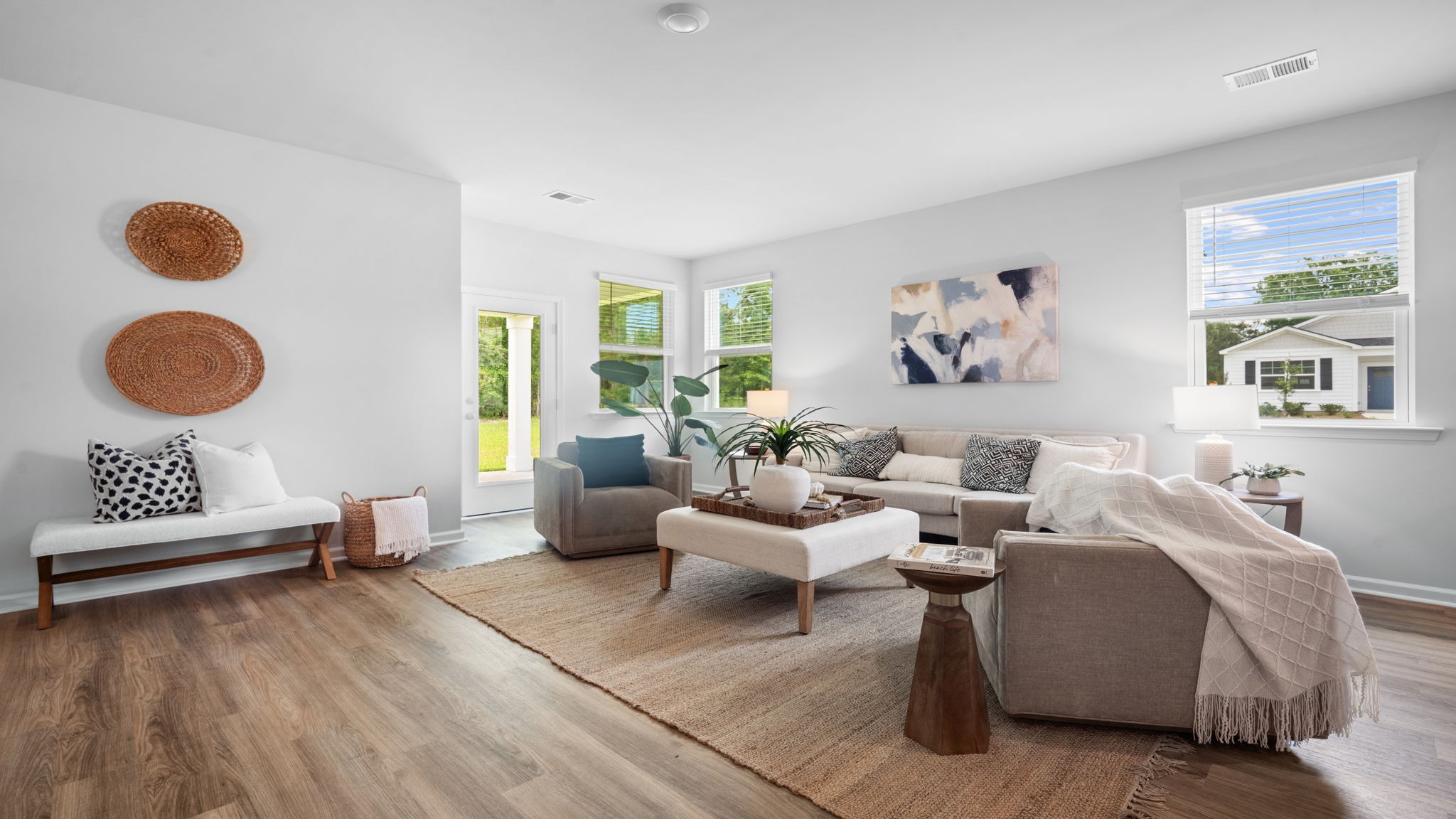 Open living room in Lakeside floor plan with natural light, spacious layout, and direct connection to kitchen and dining area