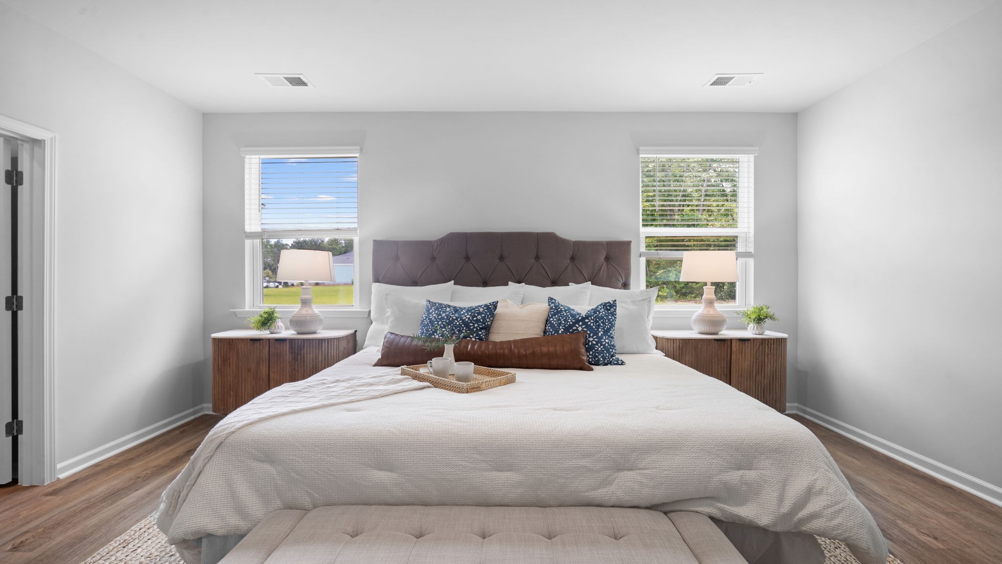 Primary suite with dual vanities and walk-in shower in Lakeside model designed for comfort and functionality