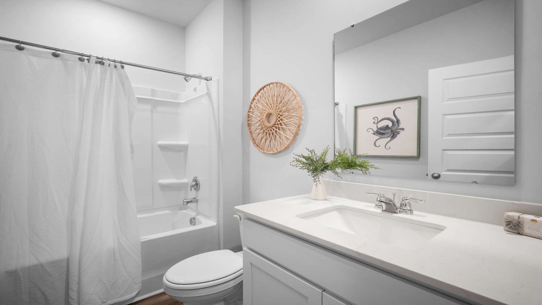 Guest bathroom in Lakeside floor plan Laurel Grove with clean finishes and convenient access for visitors