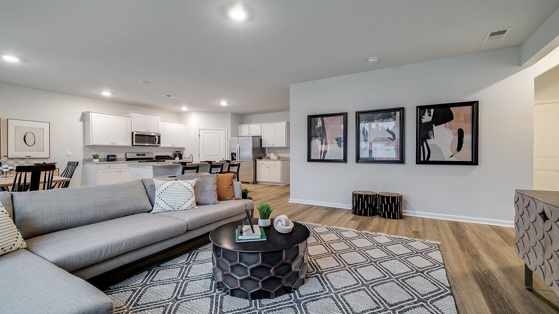 Open-concept living room in Hayden floor plan with natural light, spacious layout, and direct view into kitchen and dining area