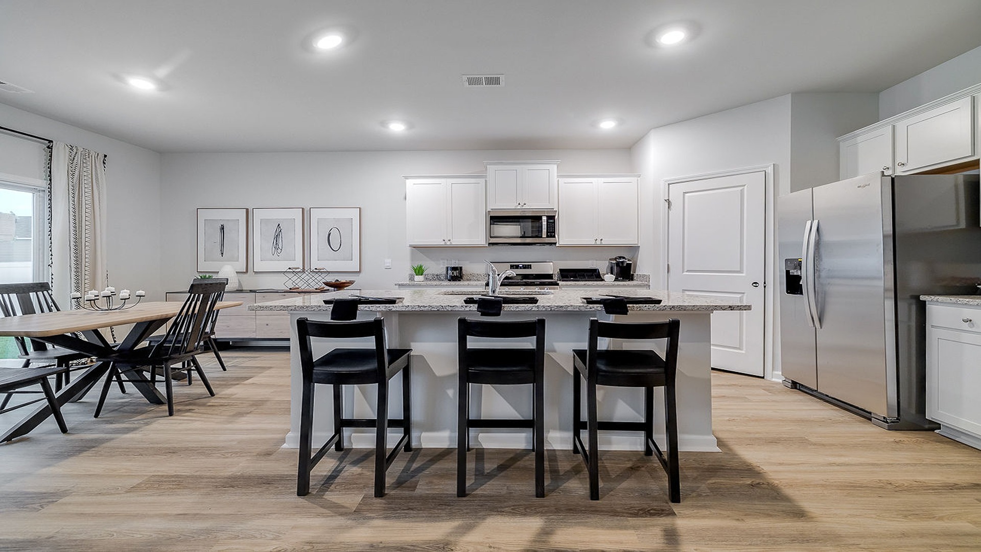 Dining area off kitchen in Hayden model with open flow and modern finishes perfect for gatherings