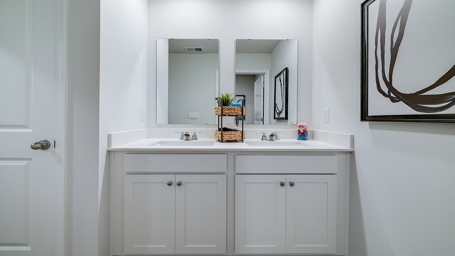 dual vanity sink in guest bathroom featuring modern finishes