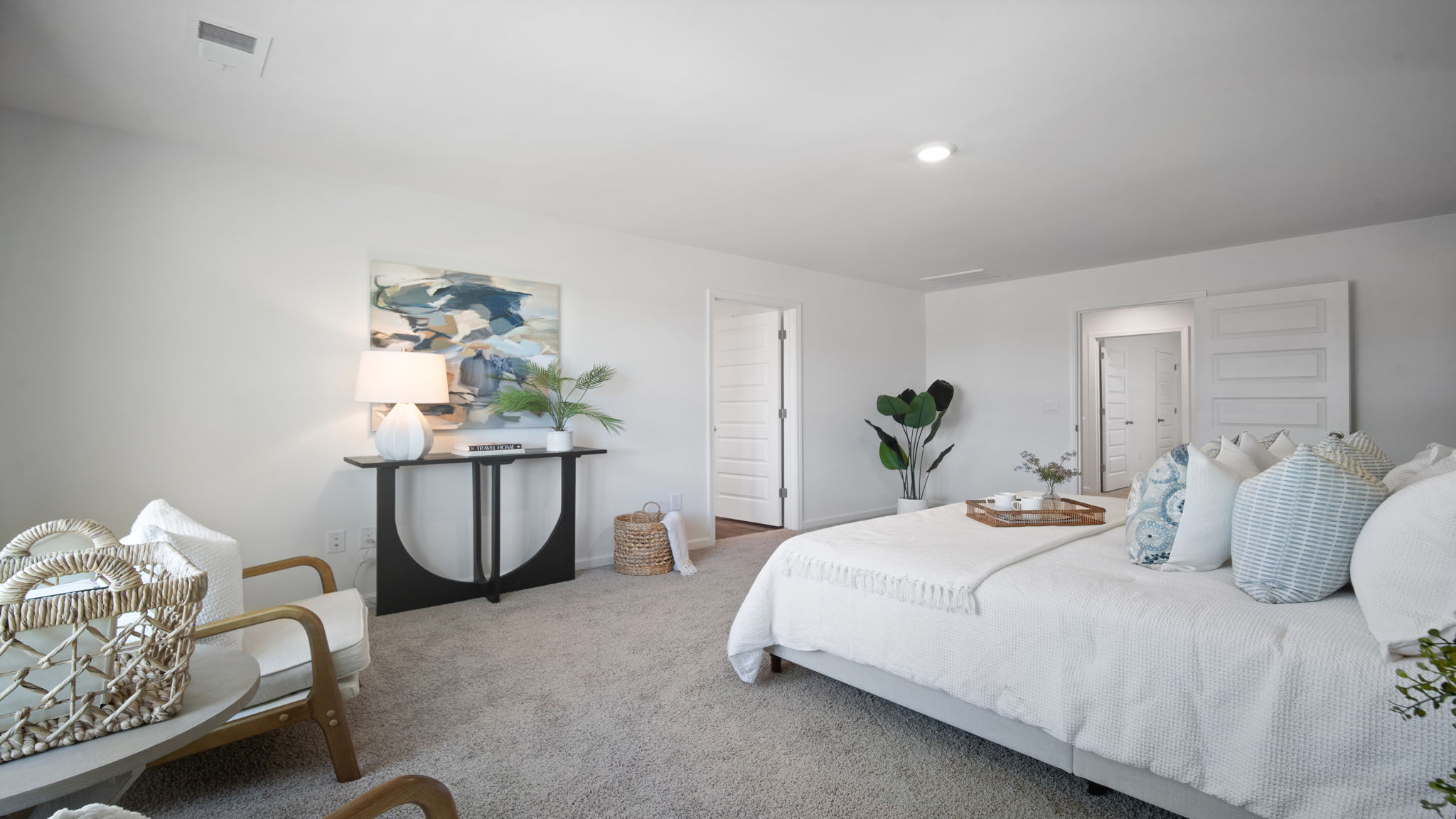 Beautiful owner's suite in the Hayden floor plan at Laurel Grove featuring modern design details, ample living space, and convenient access to a spa-inspired en-suite bathroom.