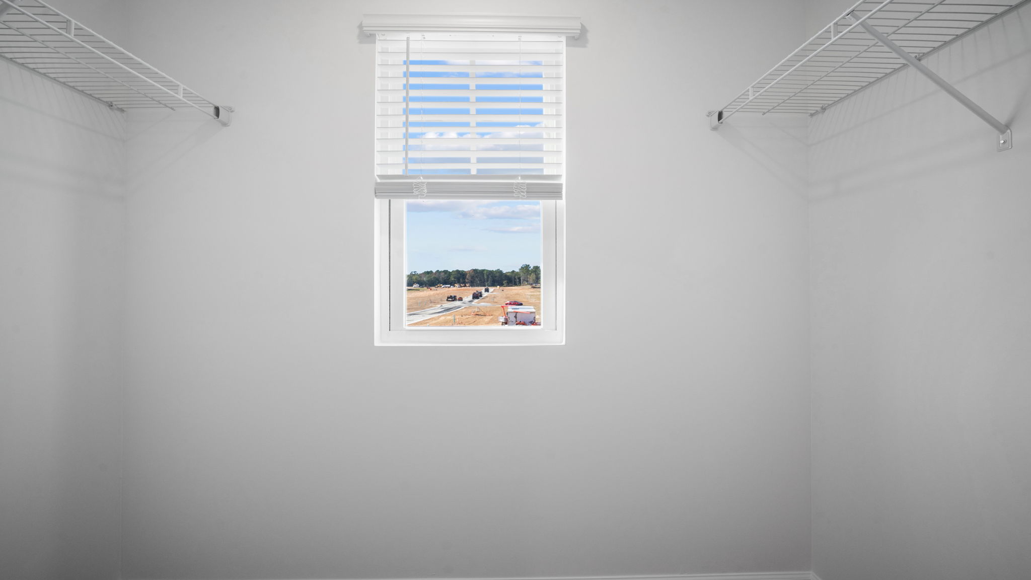 Spacious walk-in closet in the Hayden floor plan at Laurel Grove by D.R. Horton featuring ample storage space, organization potential, and convenient access from the primary suite."