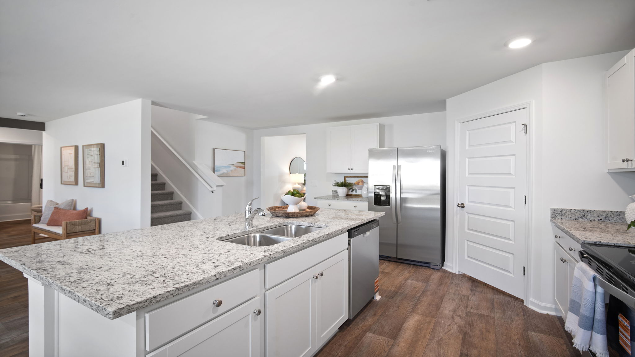 Large center island in the Hayden floor plan kitchen at Laurel Grove showcasing beautiful countertops, bar seating, modern finishes, and a functional layout ideal for cooking, dining, and gathering with family and friends.