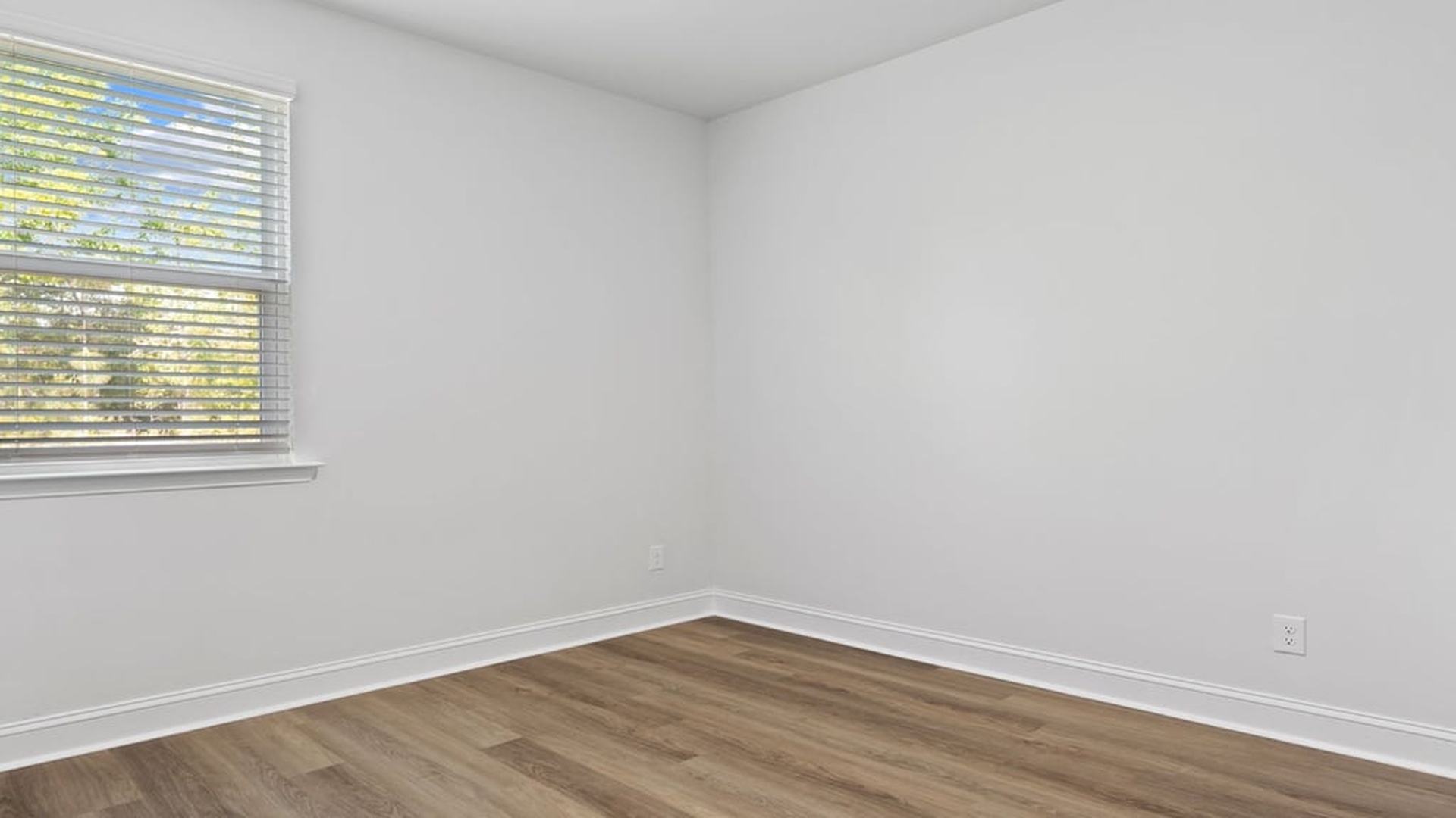 Spacious secondary bedroom in Harbor Oak model with ample natural light and closet space perfect for guests or family