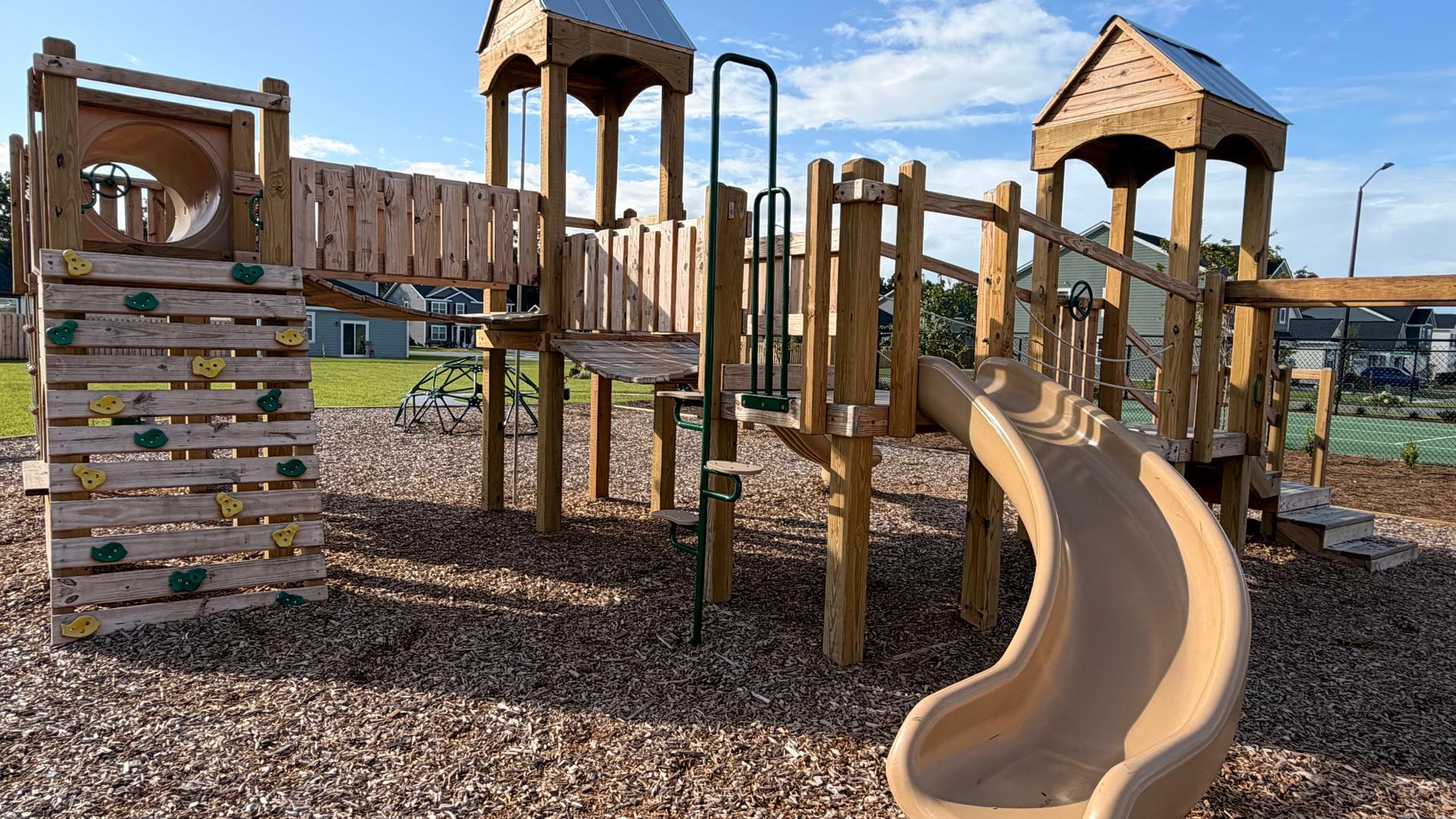 Modern playground equipment at Laurel Grove amenities.