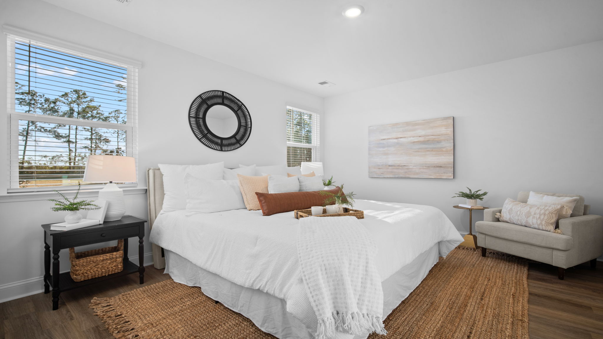 Primary bedroom with a bed and side table
