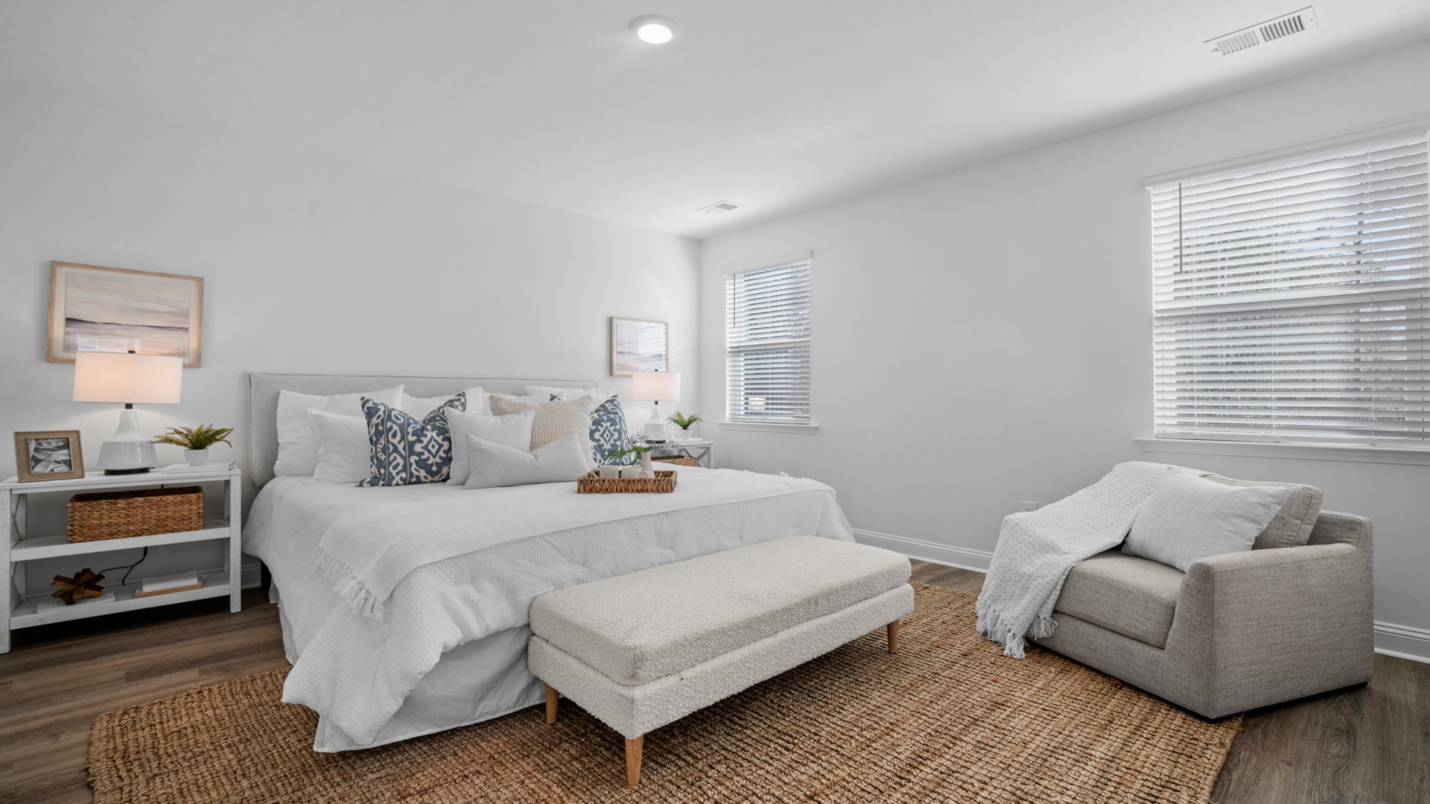 Primary bedroom with a bed and side table