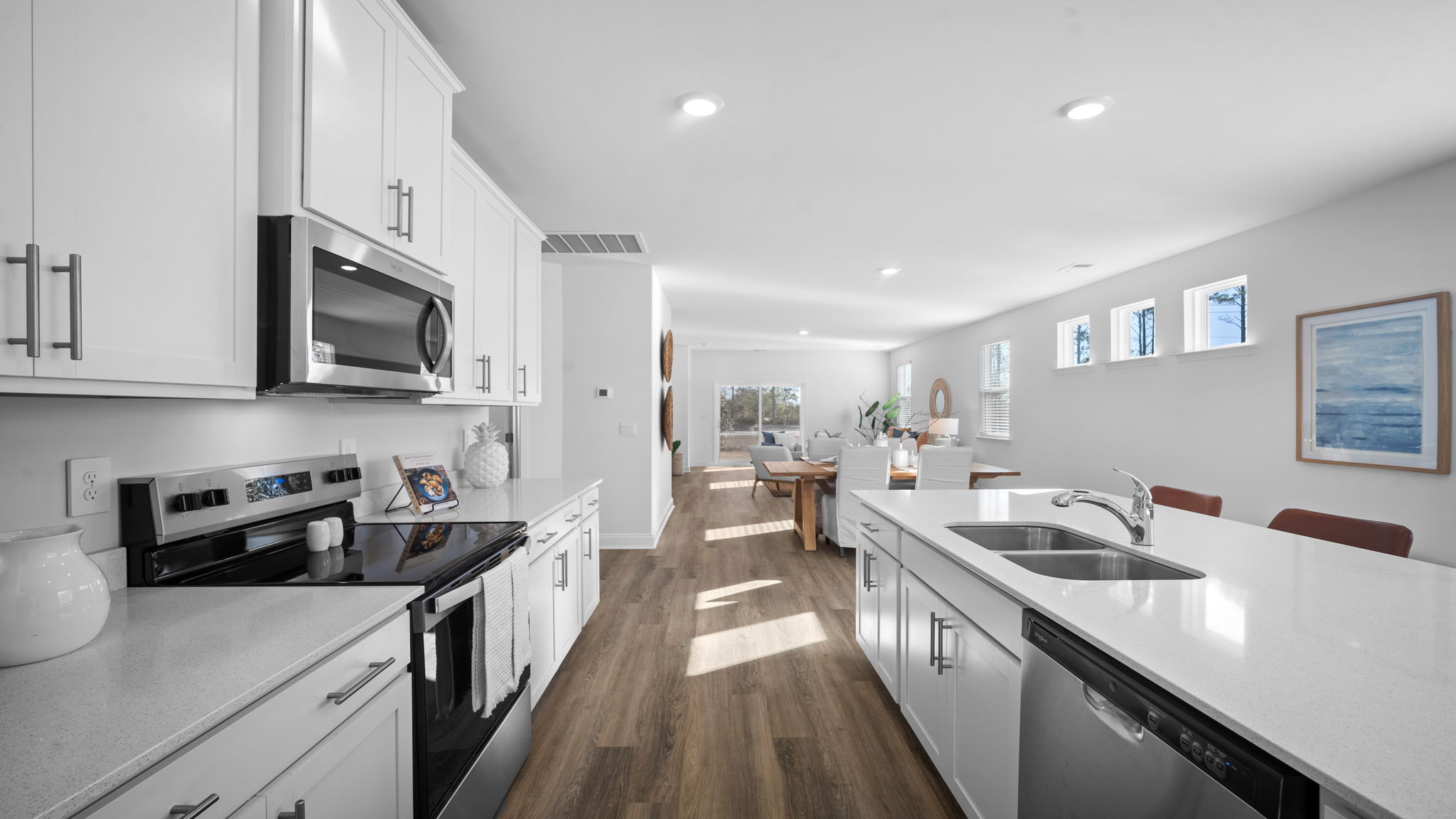 Kitchen walkway with an oven range on one side and a stainless dishwasher on the other