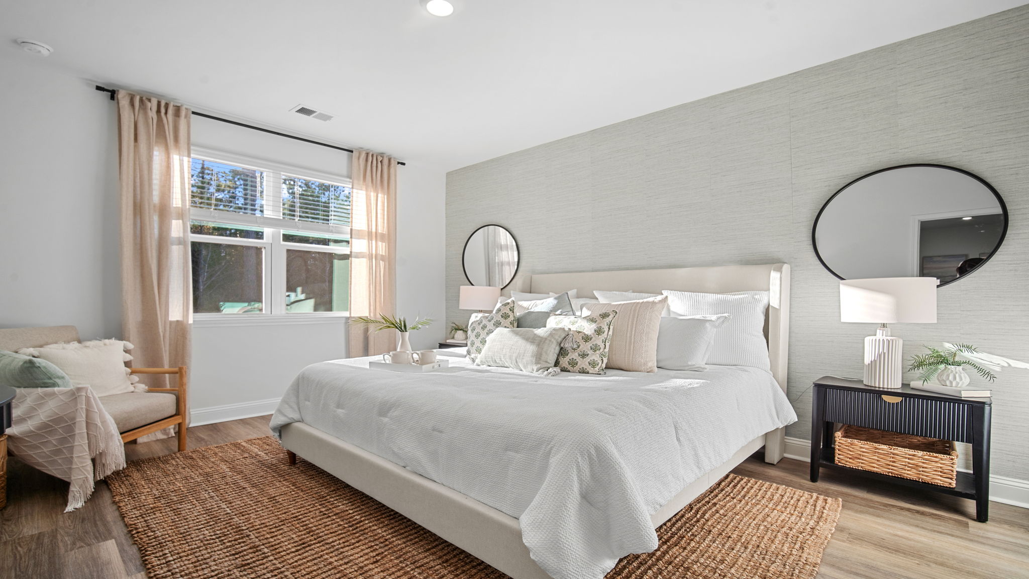 Primary bedroom decorated with a bed and side table
