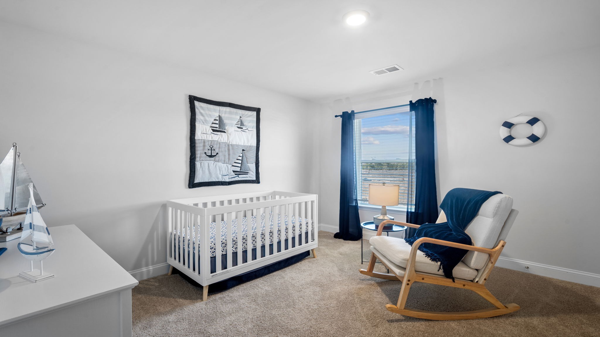 Bedroom with a rocking chair and crib