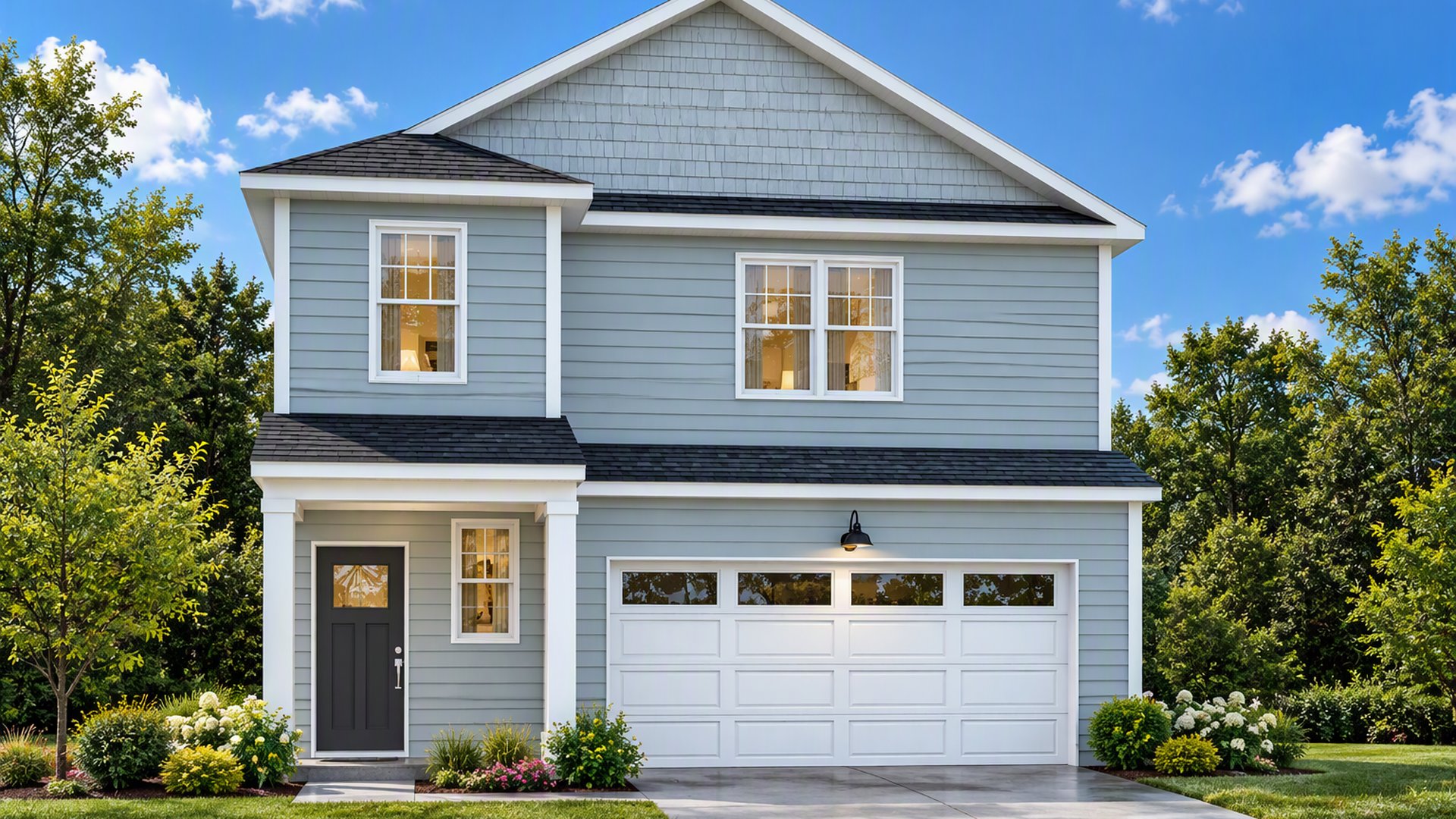 Front exterior of the Manning floorplan by D.R. Horton in Altama, featuring charming coastal-inspired architecture, a spacious two-car garage, professional landscaping, and inviting curb appeal in a desirable Georgia community.