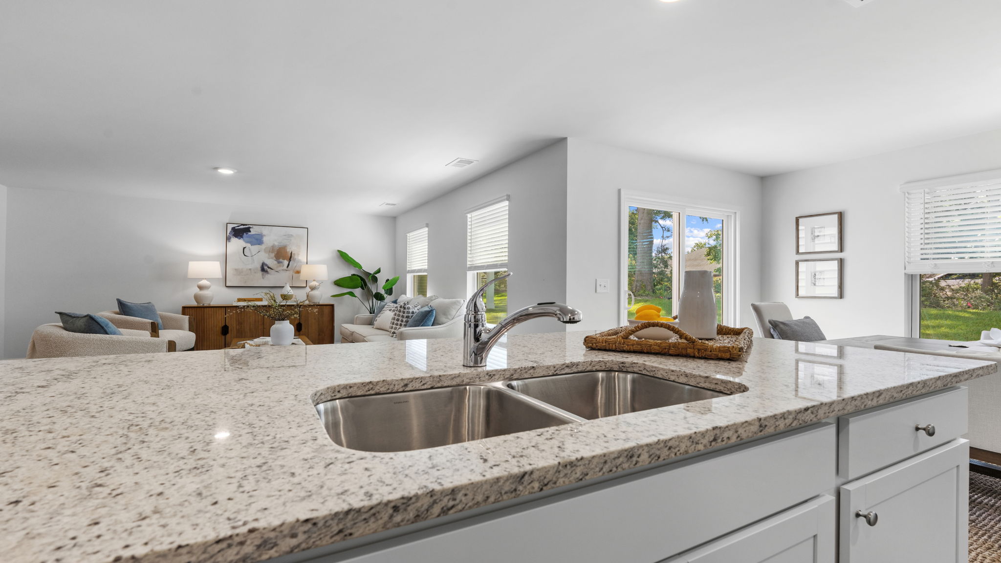 Kitchen island with undermount sink overlooking the open living area in the Darwin home.