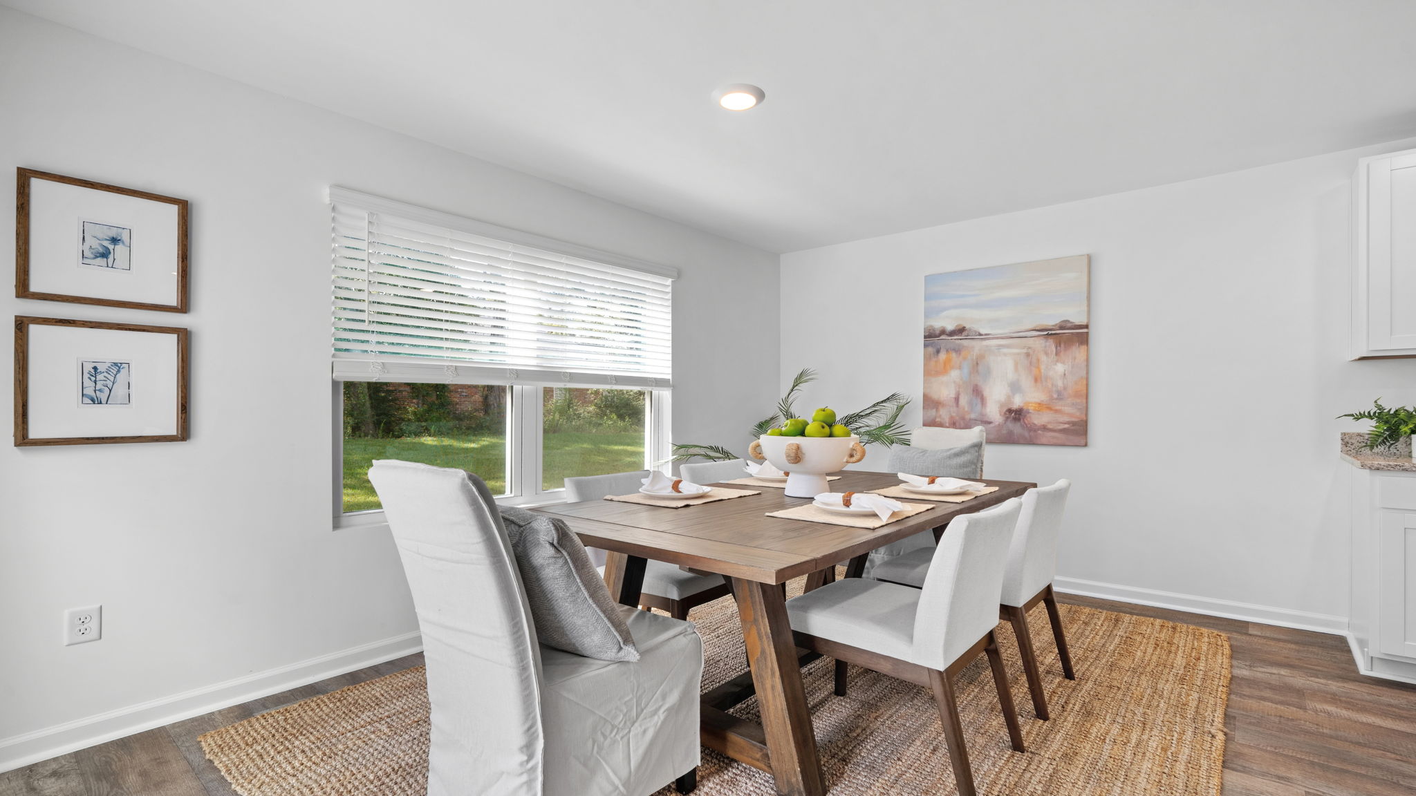 Dining room with natural light, stylish furnishings, and convenient access to the kitchen.