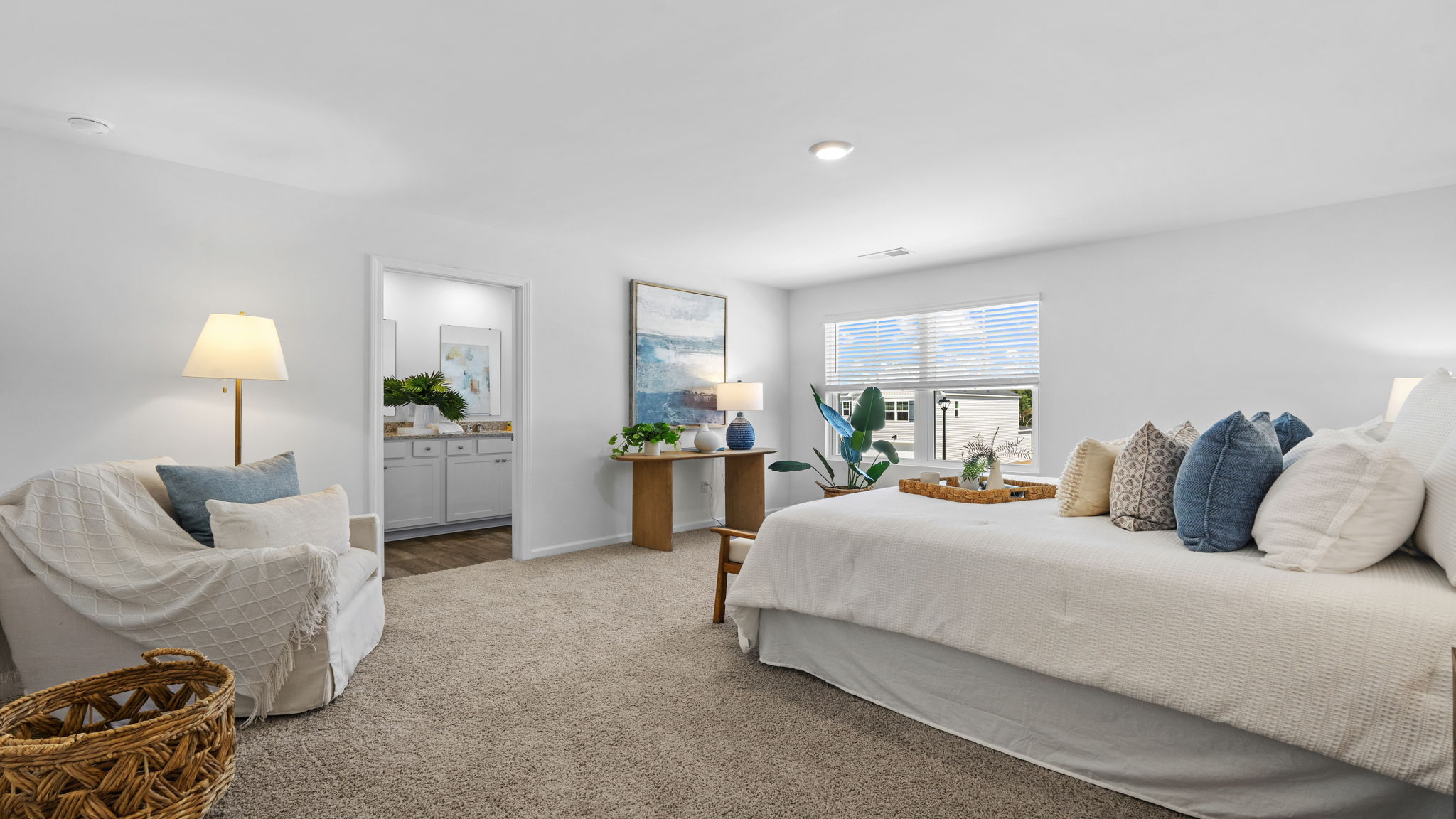 Owner's suite with spacious bedroom layout, large windows, and neutral color palette.