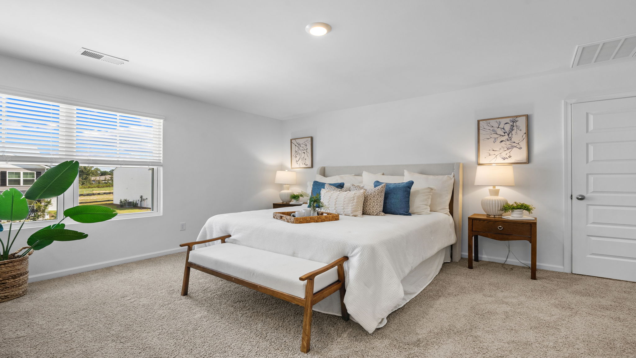 Primary bedroom in the Darwin home featuring abundant natural light and comfortable design.