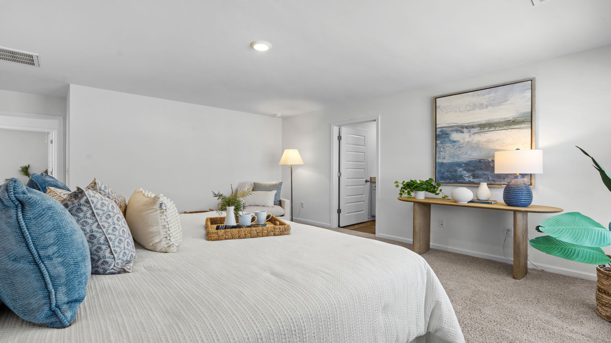 Large owner's suite with plush carpeting, elegant furnishings, and generous living space.