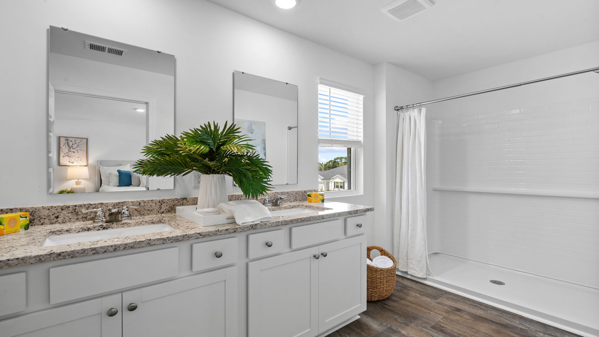 Primary bathroom with dual sinks, extended vanity, and modern finishes.