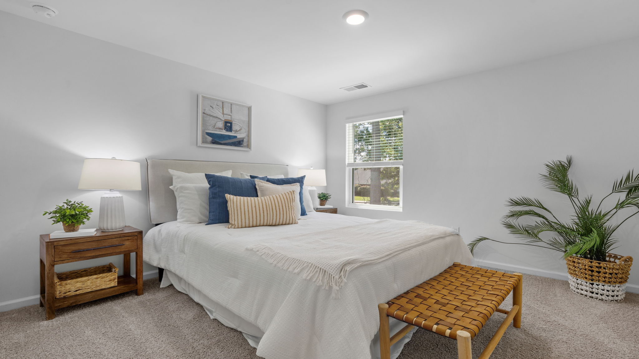 Secondary bedroom with natural light, neutral walls, and comfortable layout.