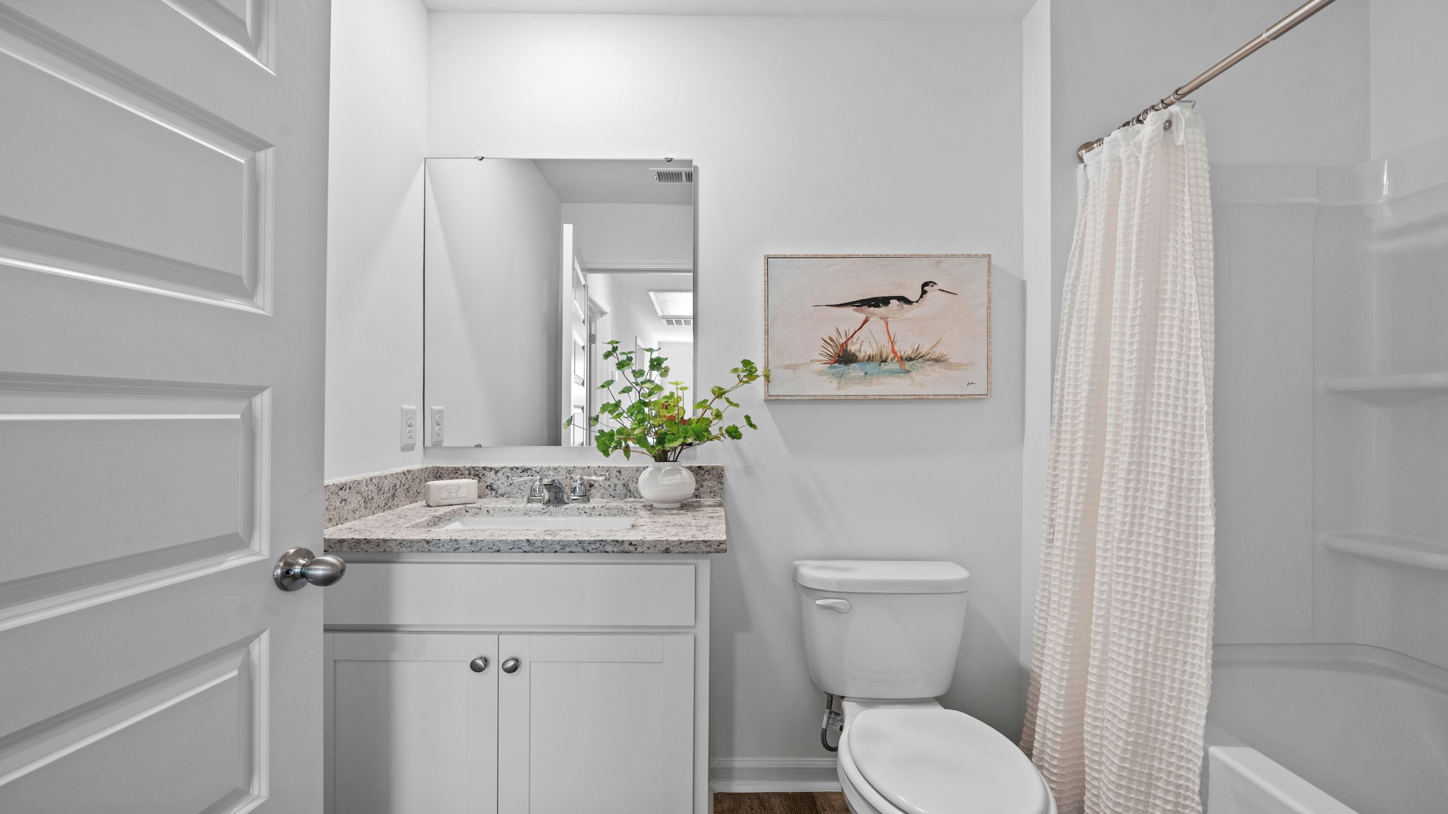 Full bathroom with vanity, shower and tub combination, and modern finishes