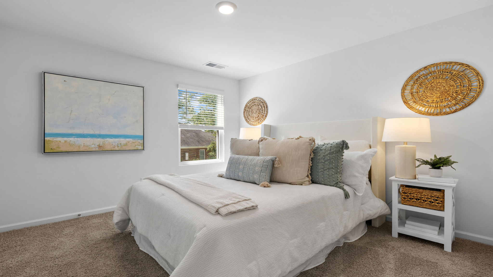 Secondary bedroom featuring natural light, neutral décor, and comfortable living space