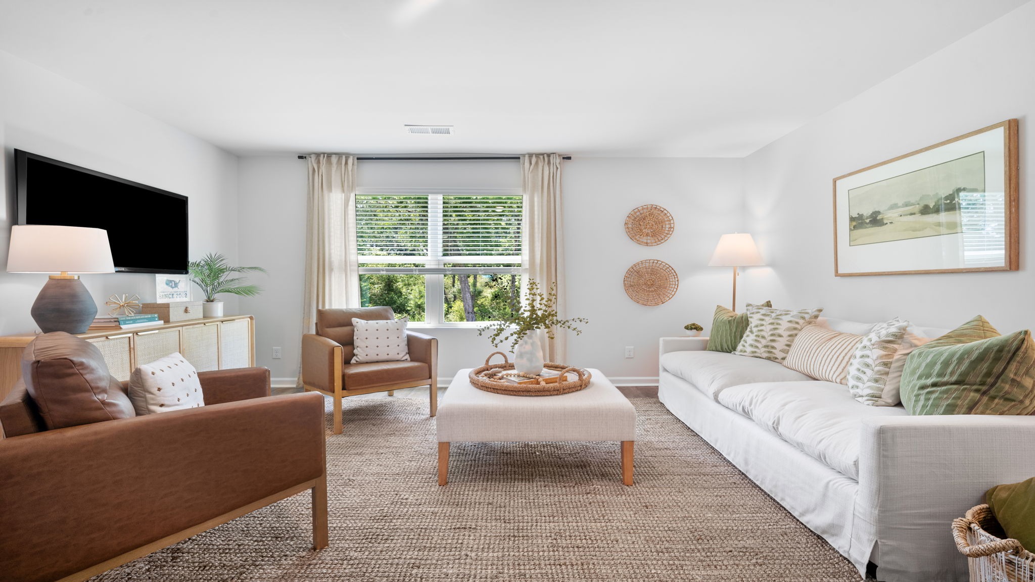 Living room decorated with a couch and chairs