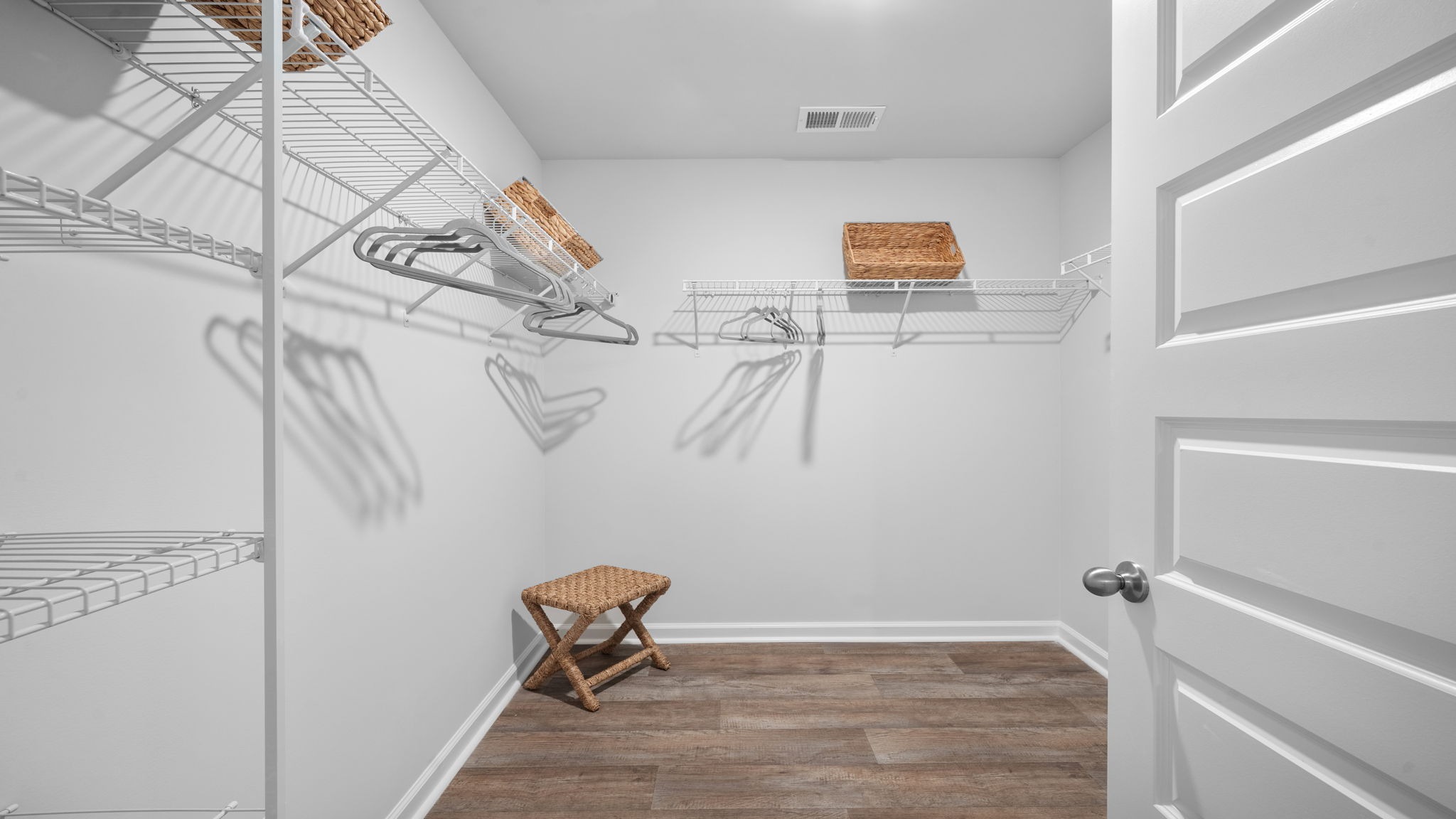 Spacious laundry area has room for a washer and dryer with built in shelves.