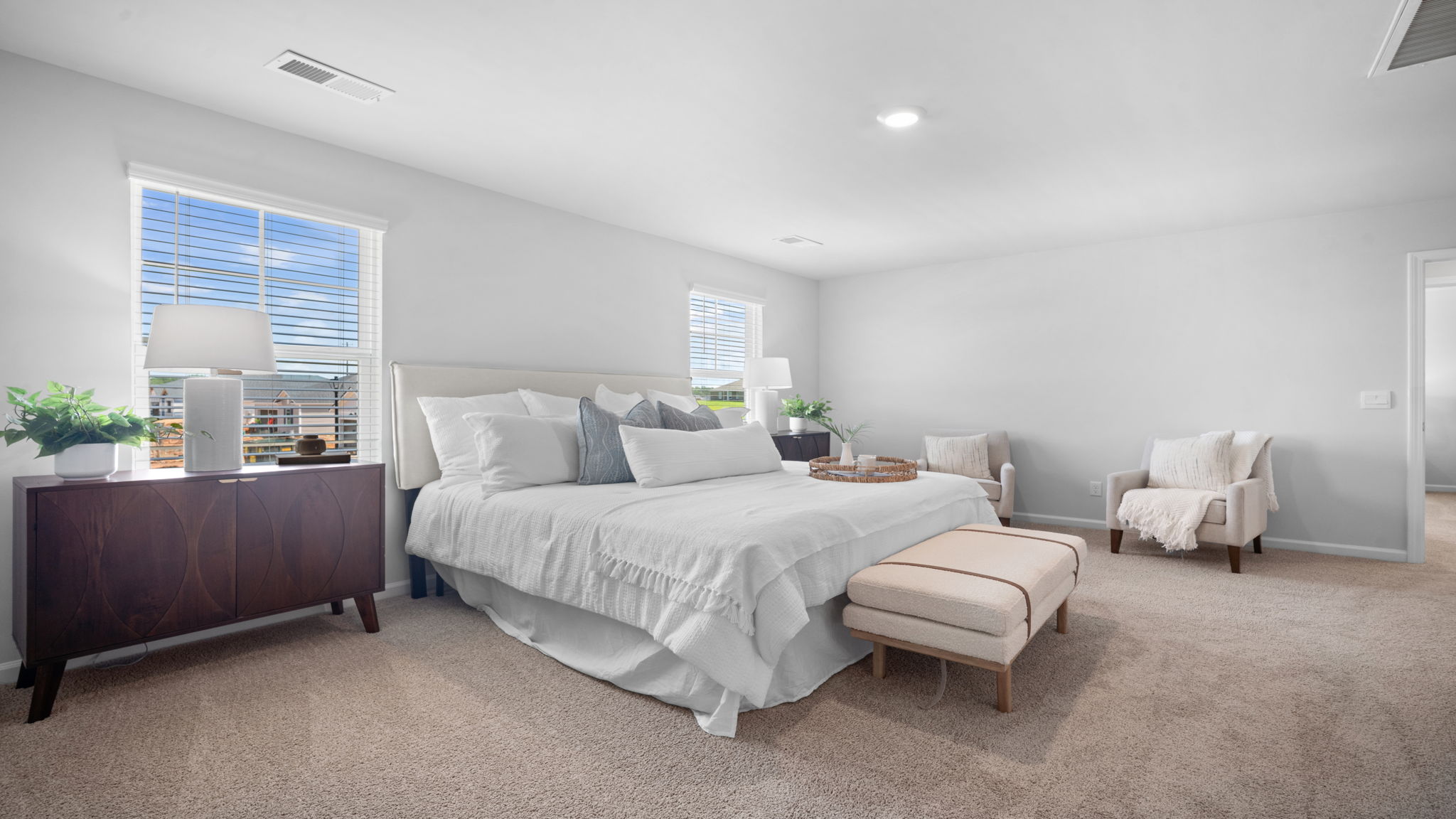 Primary bathroom with double vanities and a stand-up shower