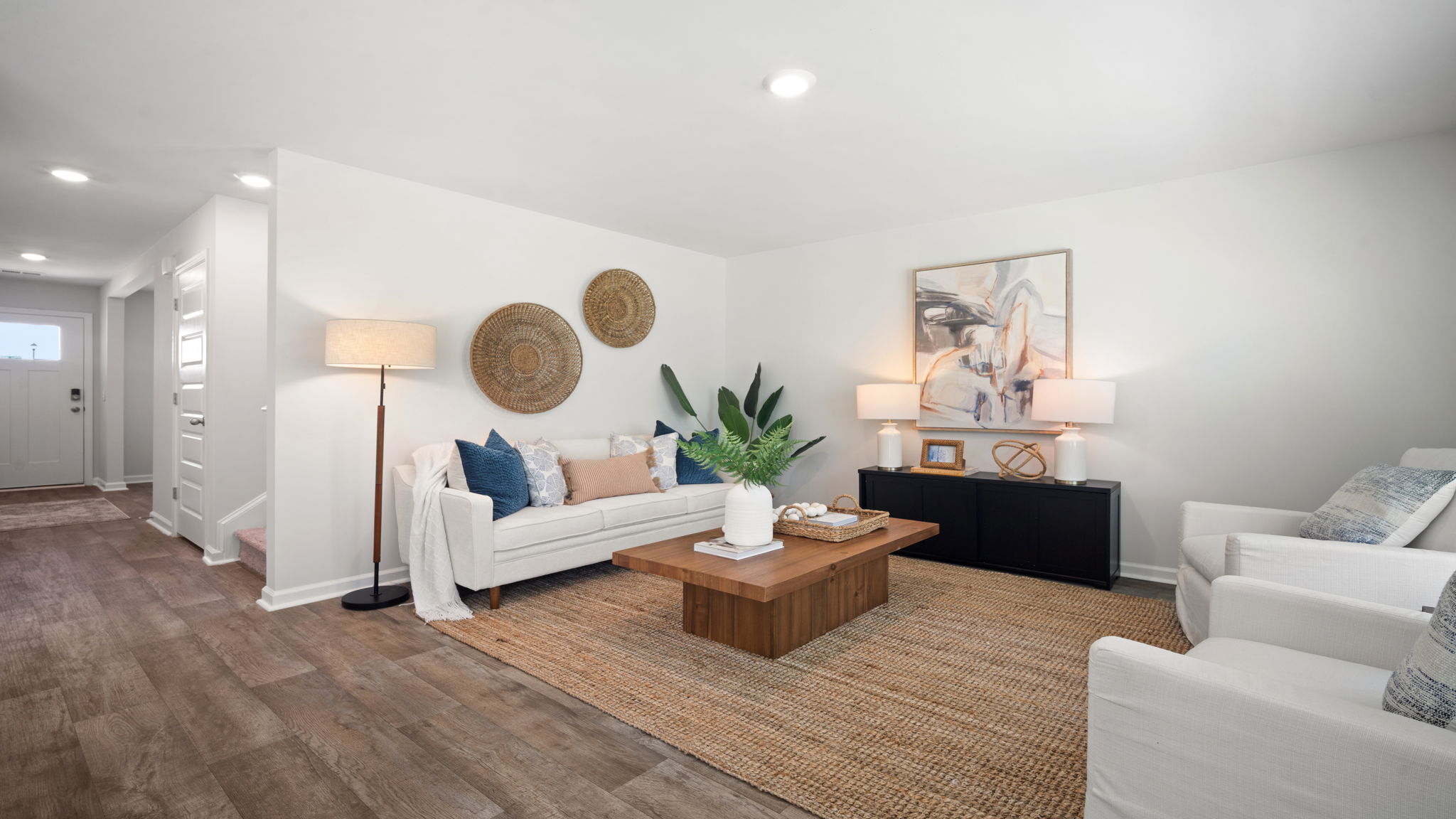 Living area decorated  with a couch, chairs and tables