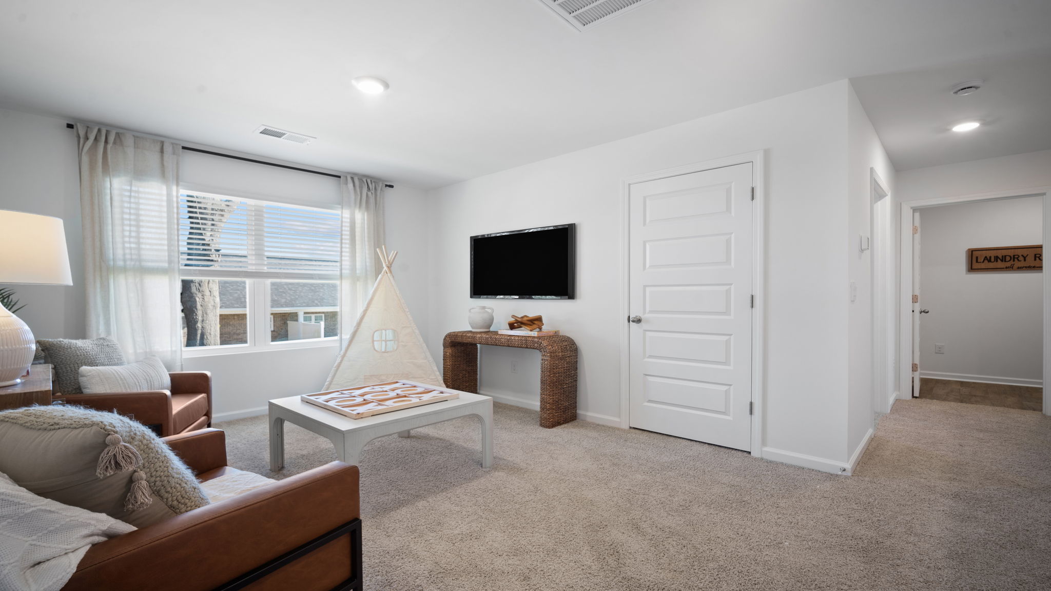 Upstairs living room with a couch, chairs and tv