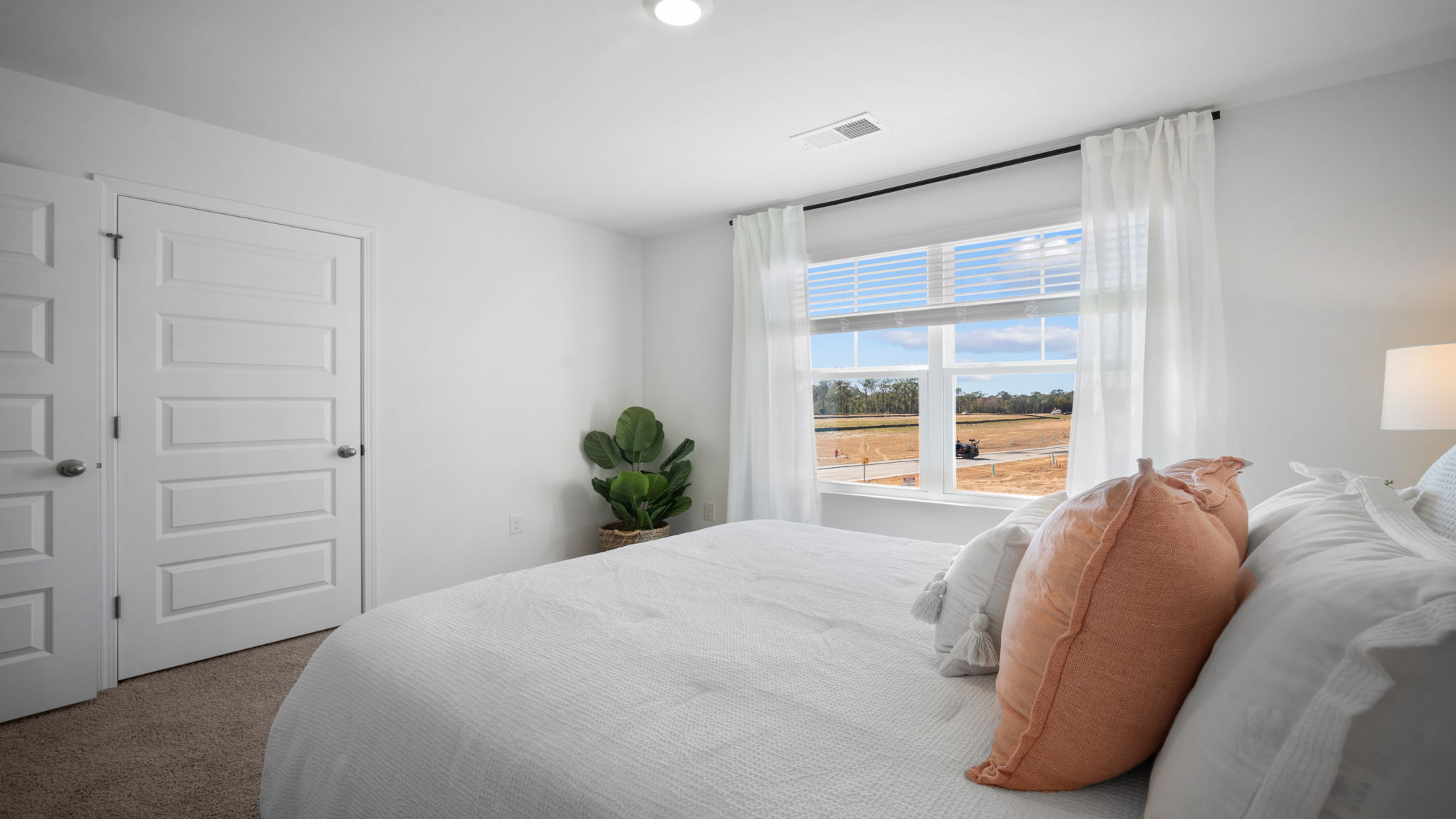Bedroom with hardwood floors and large single window for natural light.