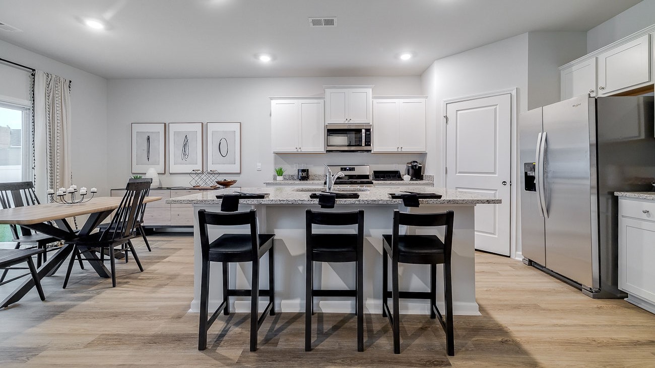 Chef-inspired kitchen with stainless steel appliances, ample cabinetry, and spacious island in DR Horton Hayden Stockyard