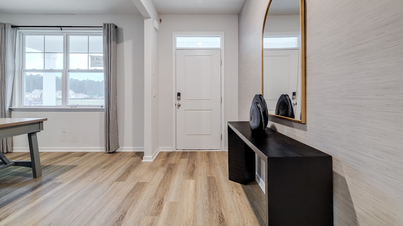 Welcoming foyer entry in Hayden floor plan leading into spacious open concept living area in DR Horton Stockyard community