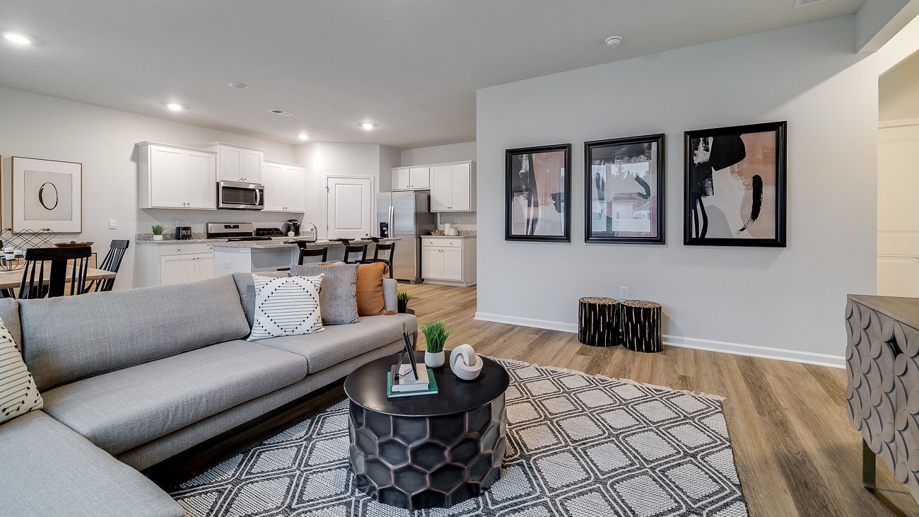 Open concept living room in Hayden DR Horton home connected to kitchen and dining space, ideal for entertaining and family living.