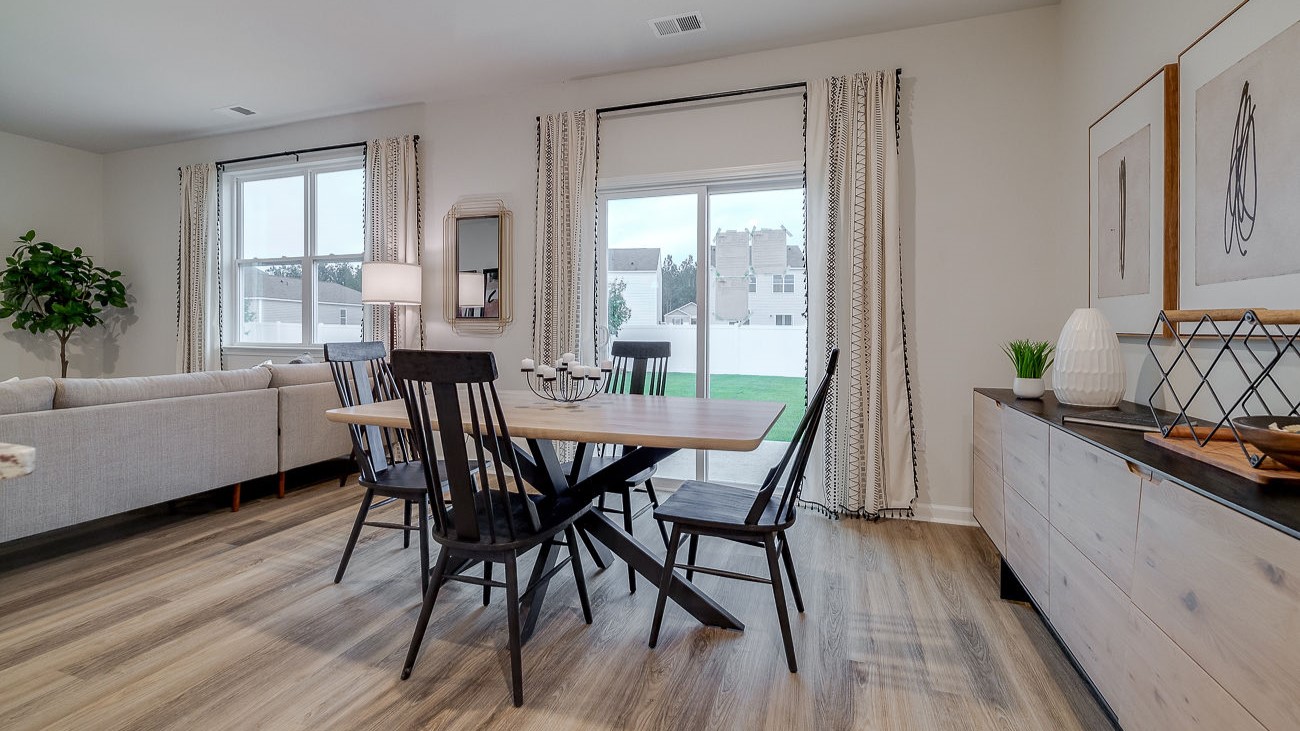 Dining area in Hayden floor plan with seamless flow to kitchen and living room in Stockyard Statesboro GA new construction home