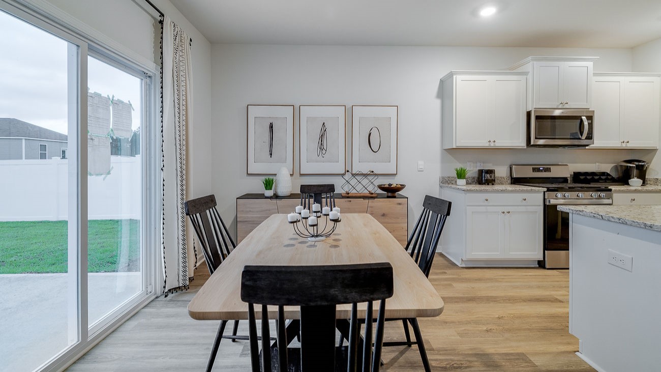 Dining area in Hayden floor plan with seamless flow to kitchen and living room in Stockyard Statesboro GA new construction home