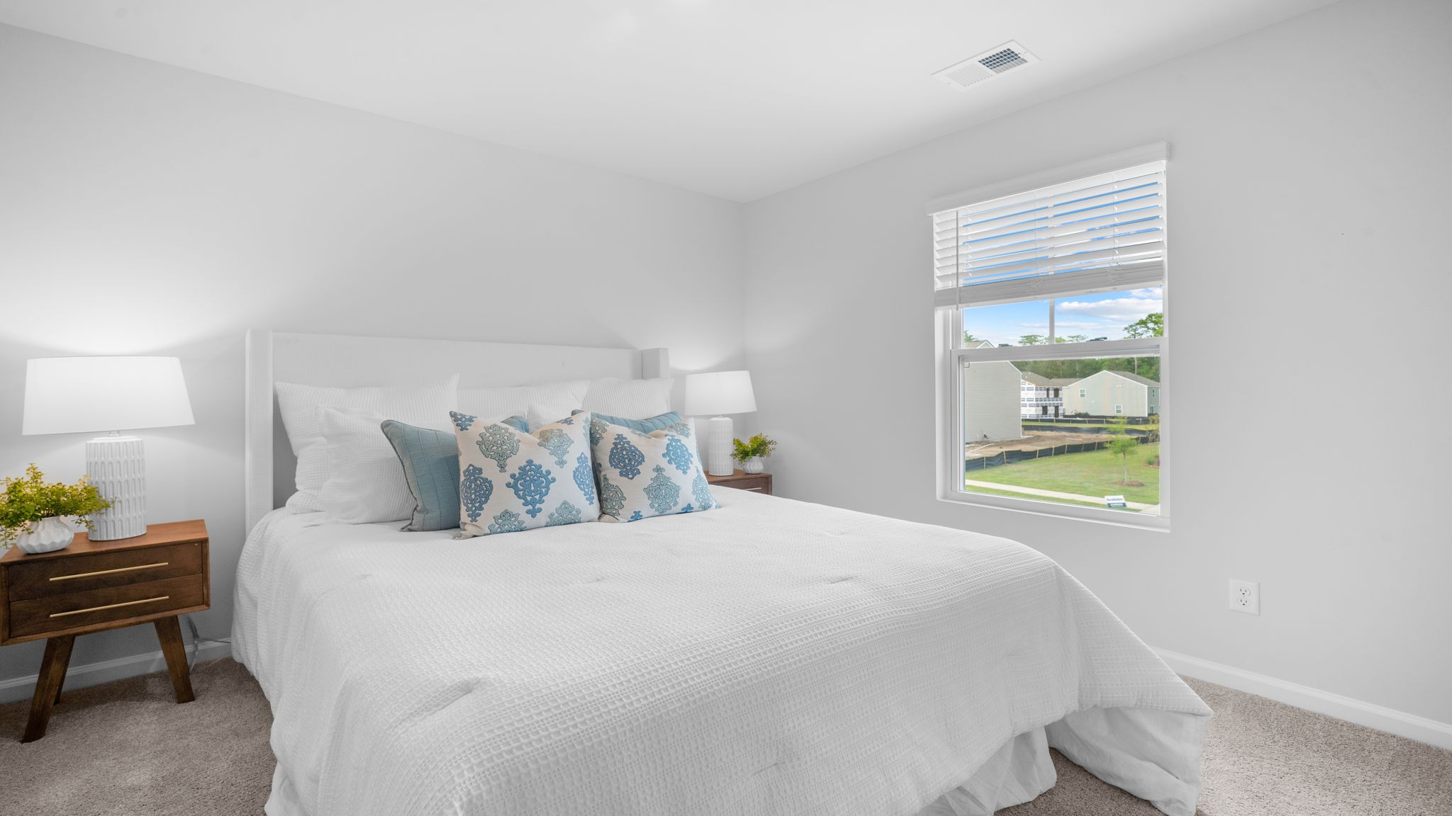 Guest bedroom with a bed and side table