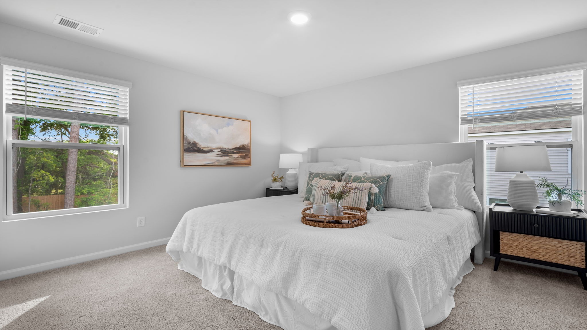 Primary bedroom with a bed and side table