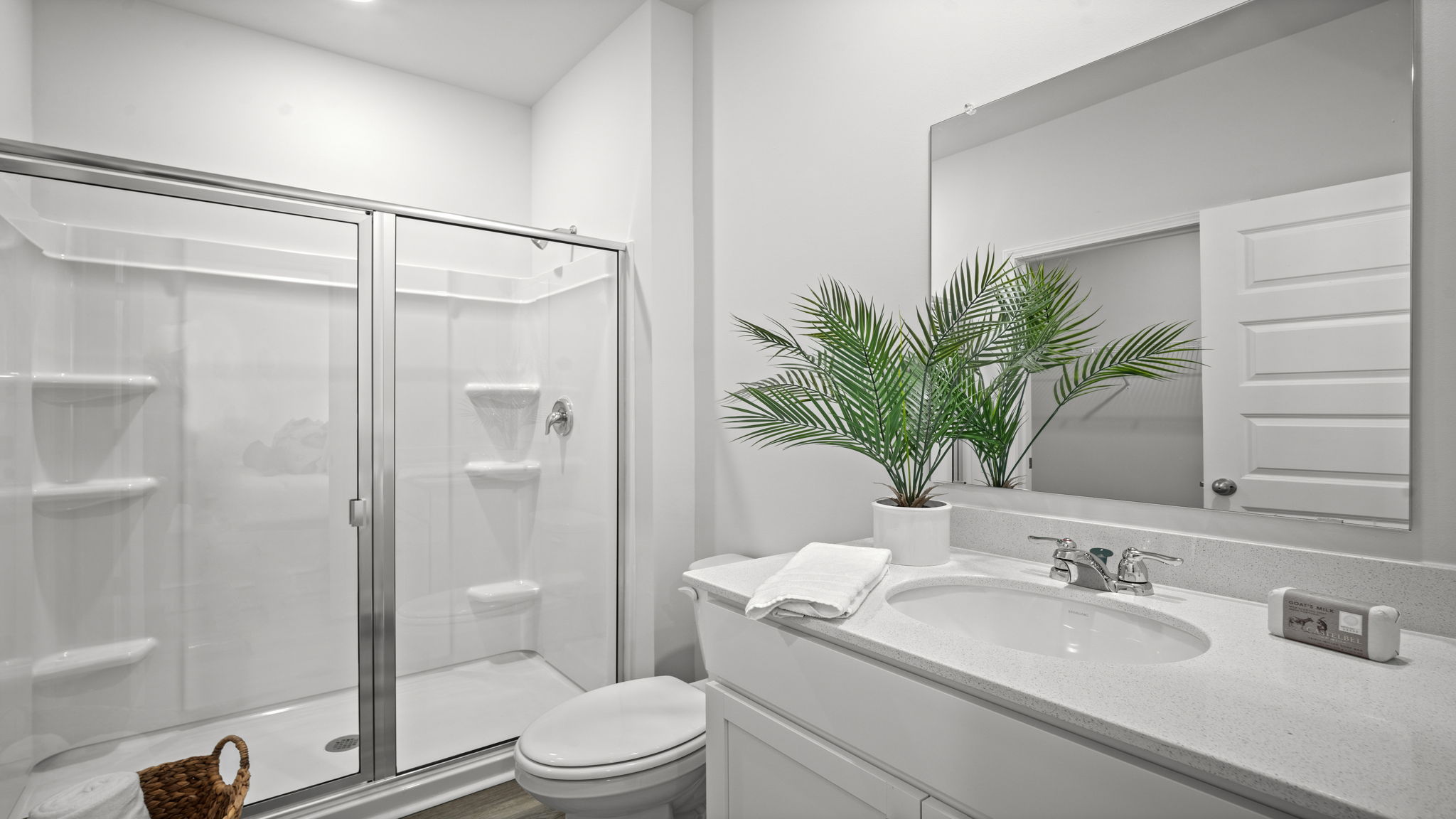 Spa-inspired owner's bath featuring dual vanities, walk-in shower, and contemporary finishes.