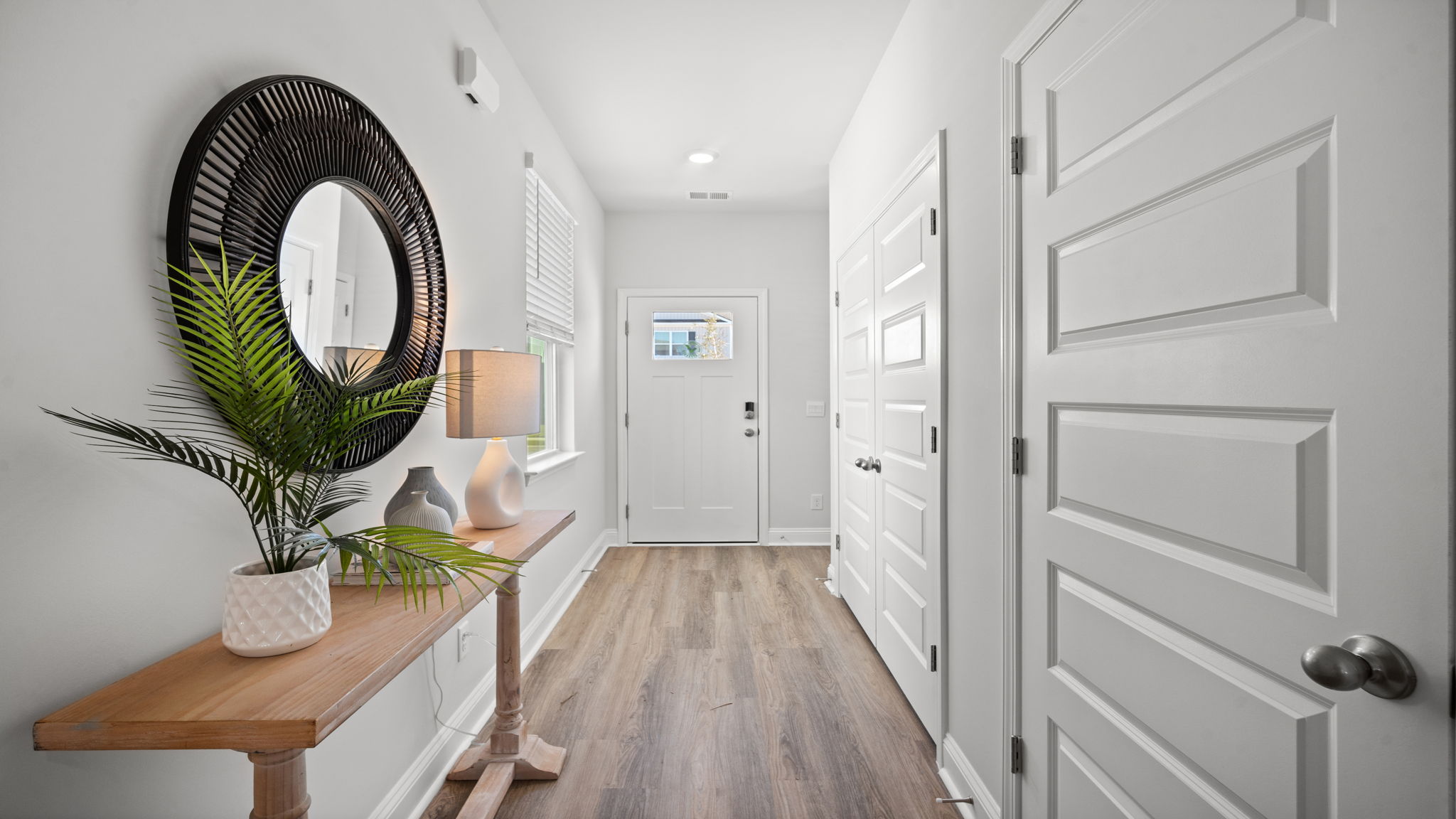 Bright and welcoming foyer with open sightlines leading to the main living spaces.