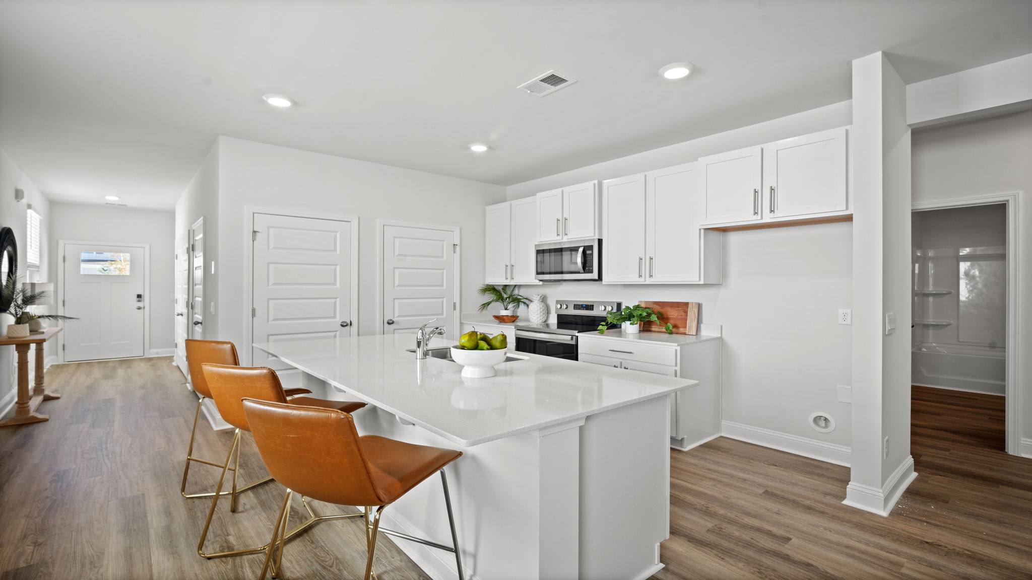 Large center island providing additional seating, prep space, and storage in the Downing floor plan.