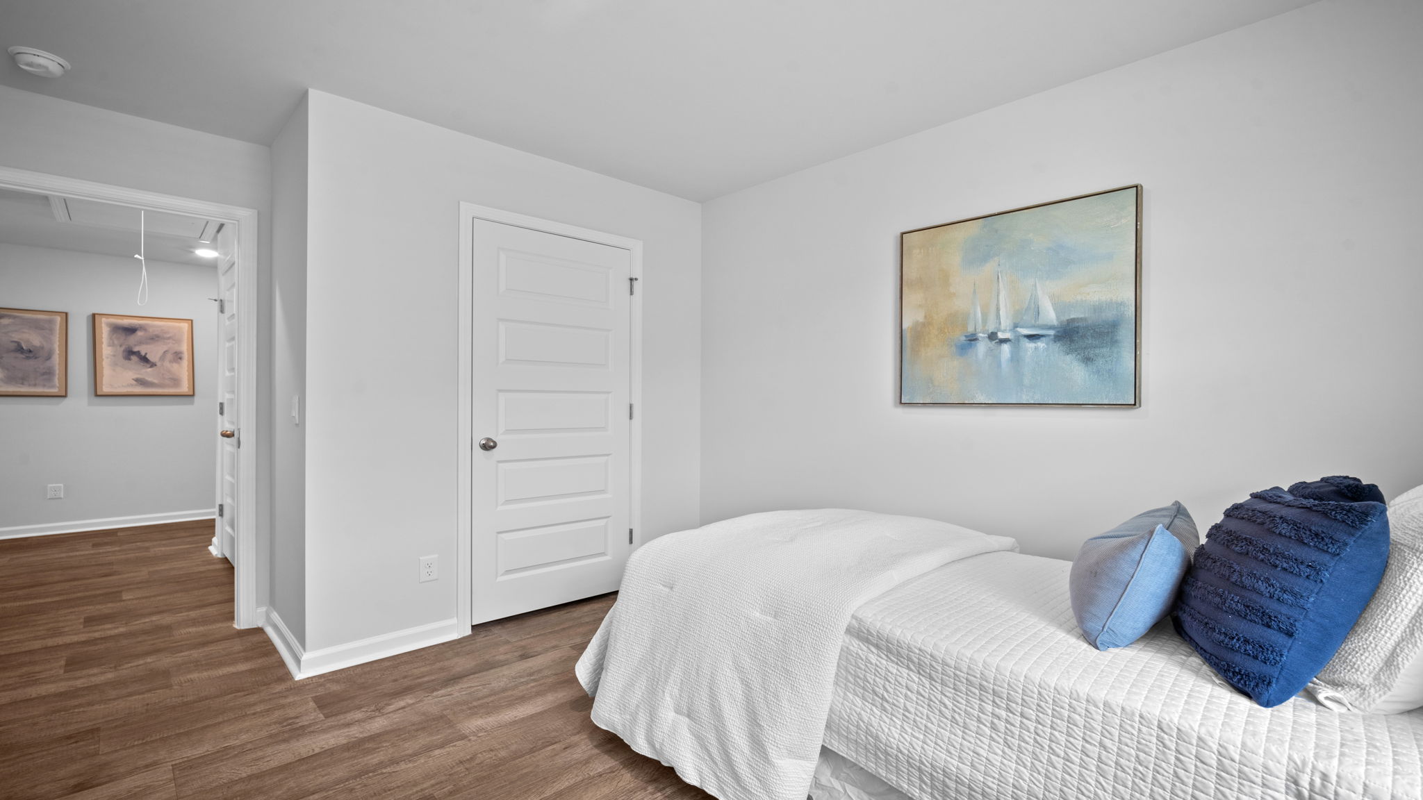 Guest bedroom decorated with a bed and side table