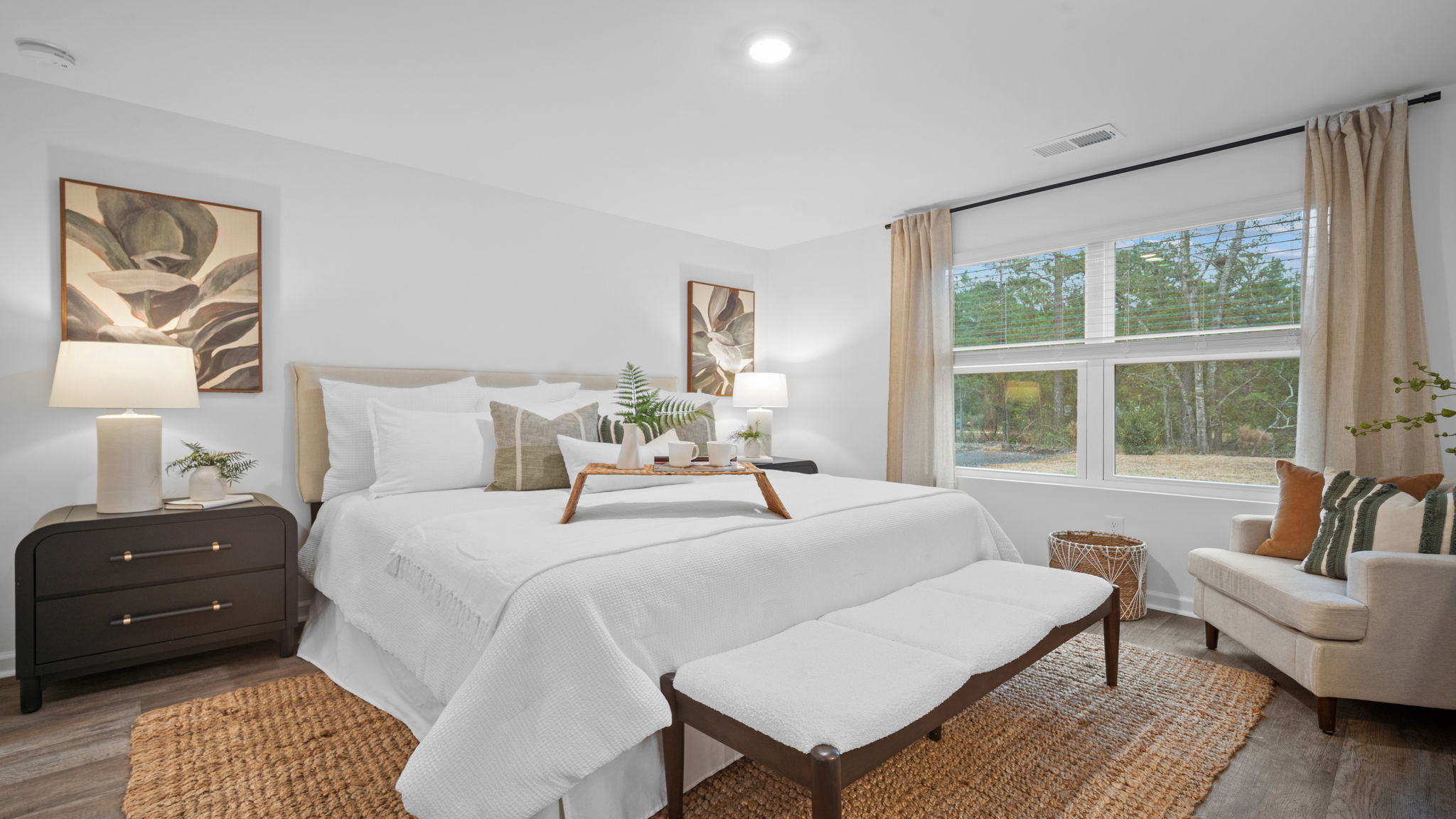 Primary bedroom decorated with a bed and side table