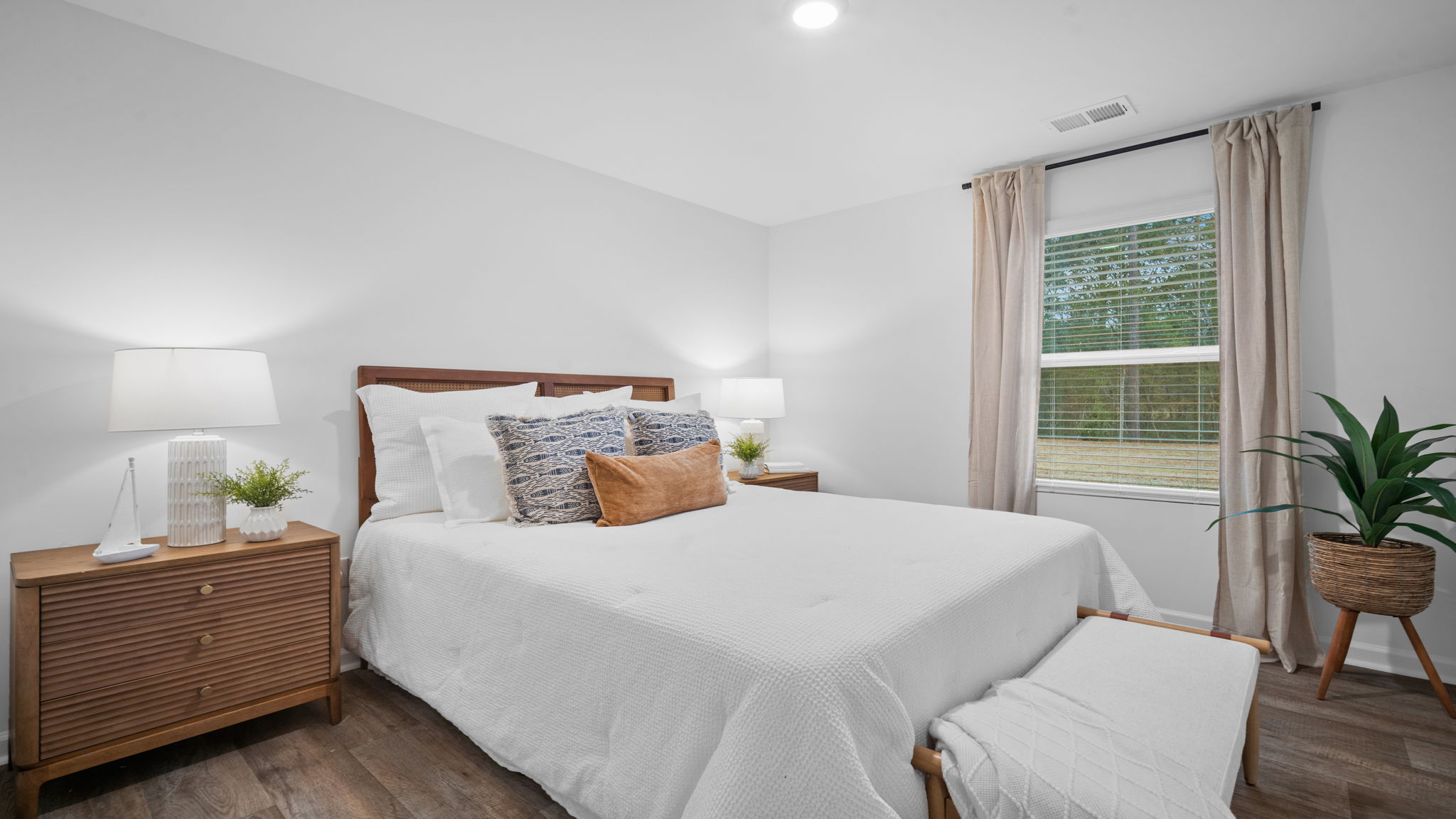 Guest bedroom with a bed and side table